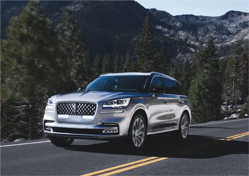 A 2023 Lincoln Aviator® Grand Touring SUV being driven on a winding road to demonstrate the capabilities of all-wheel drive | Doggett Lincoln of Beaumont in Beaumont TX